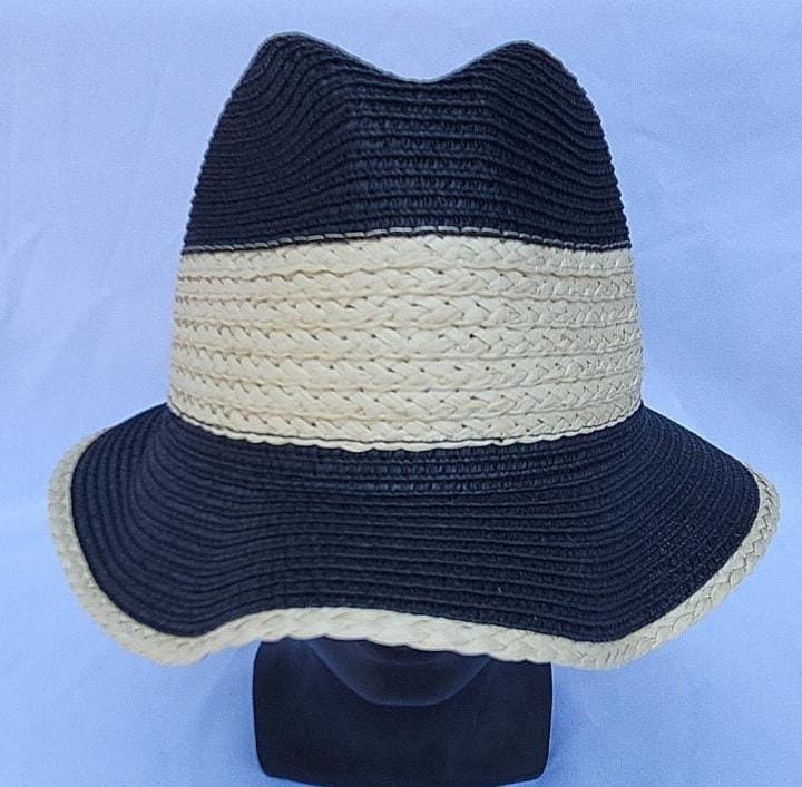 Black and cream two-tone woven straw hat on display stand.