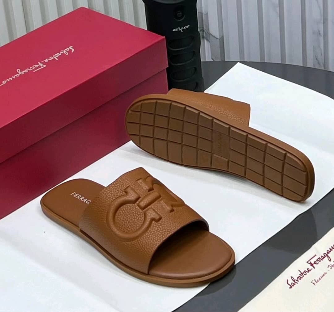 Brown Salvatore Ferragamo slides with logo, shown with red box and sole view.