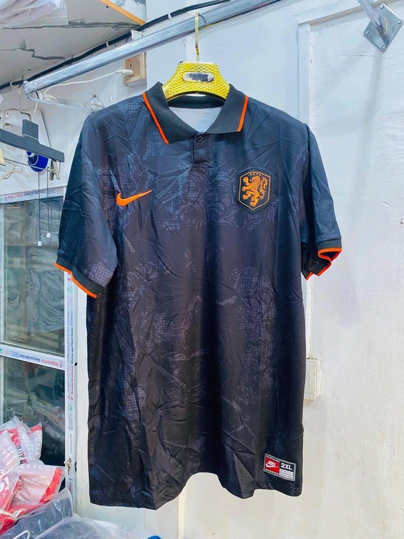 Black patterned Netherlands soccer jersey with orange accents and Nike logo.