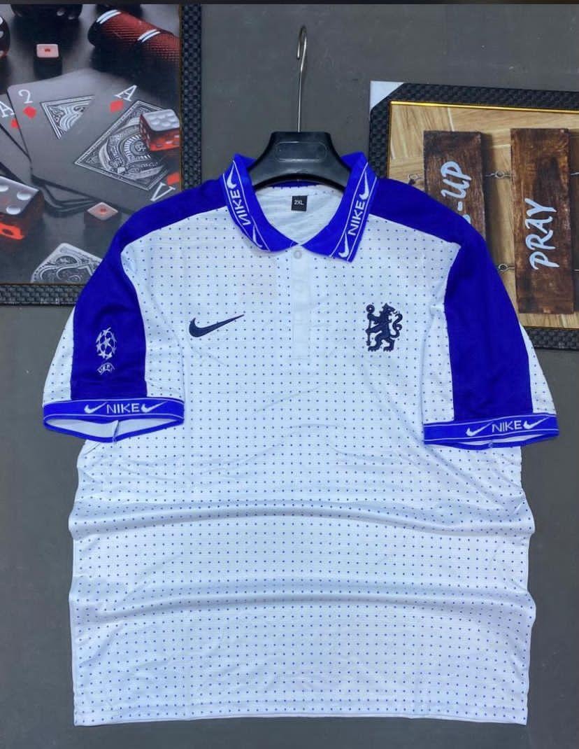 White and blue Nike Chelsea soccer jersey with dotted pattern and crest.