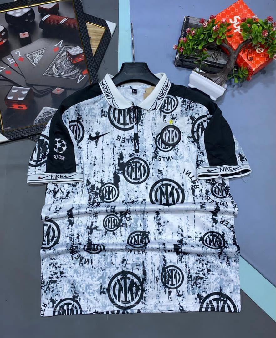 White and black Nike Inter Milan all-over print soccer jersey on hanger.