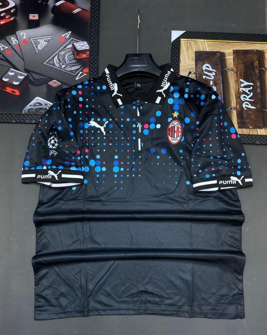 Black Puma AC Milan polka dot soccer jersey with colorful dots and logos.