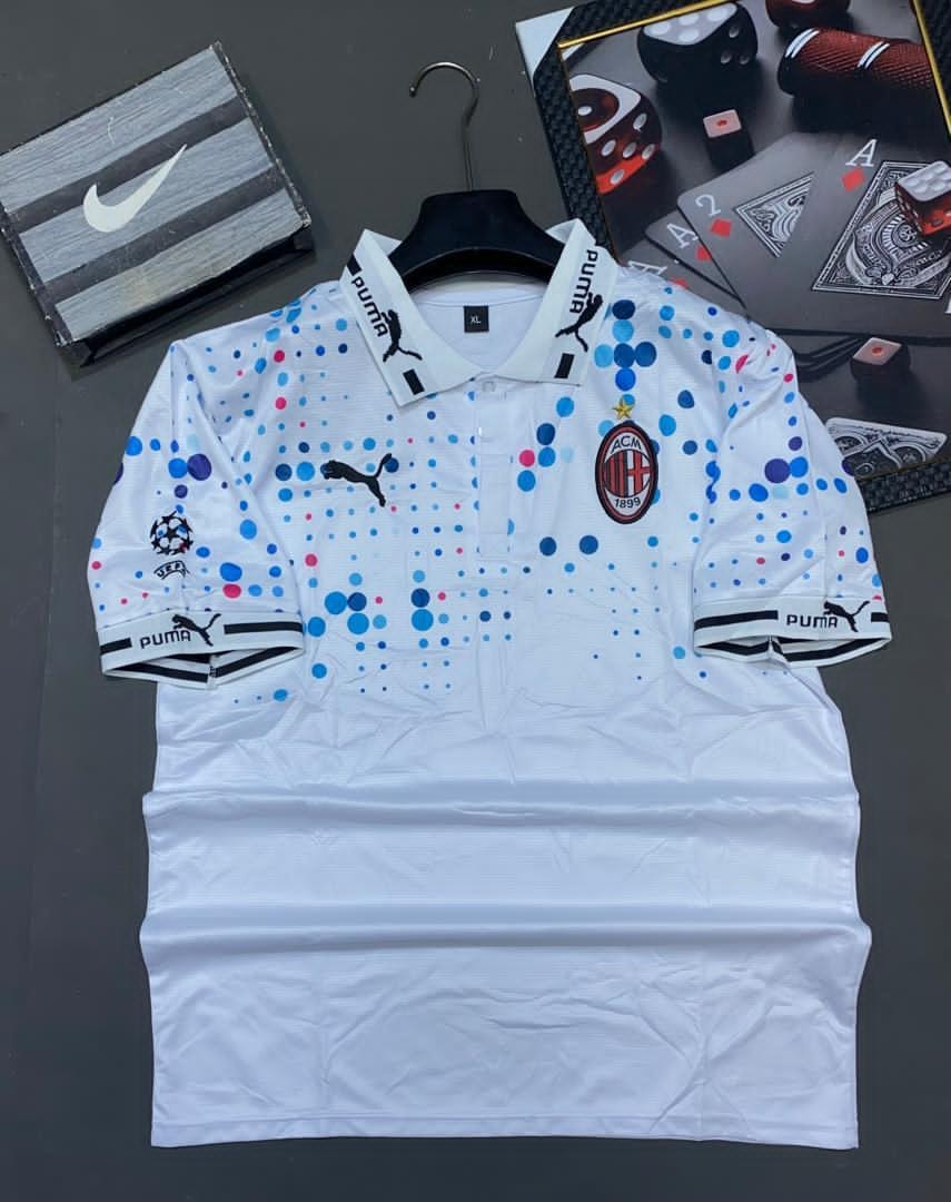 White Puma AC Milan polka dot soccer jersey with colorful dots and logos.