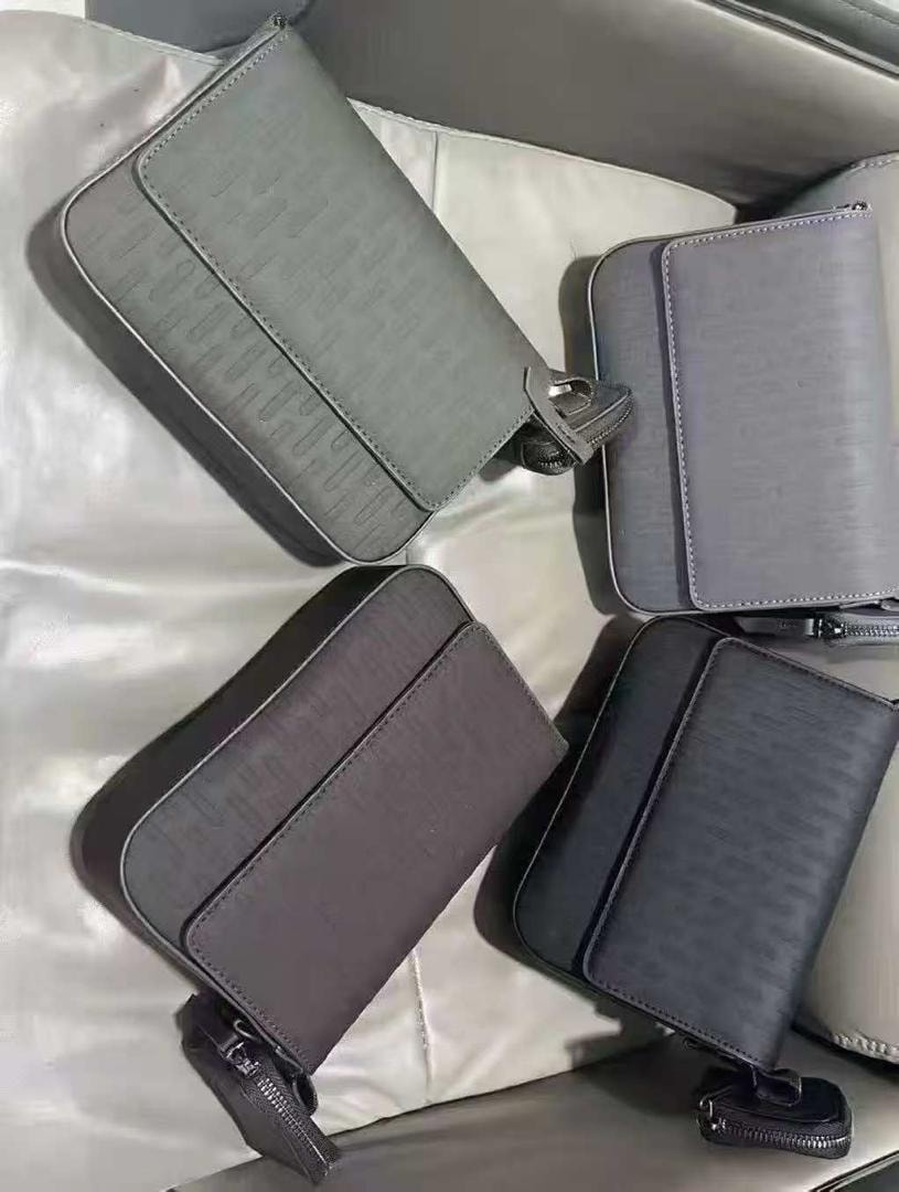 Multiple embossed monogram crossbody bags in light gray, gray, brown, black and dark gray tones.