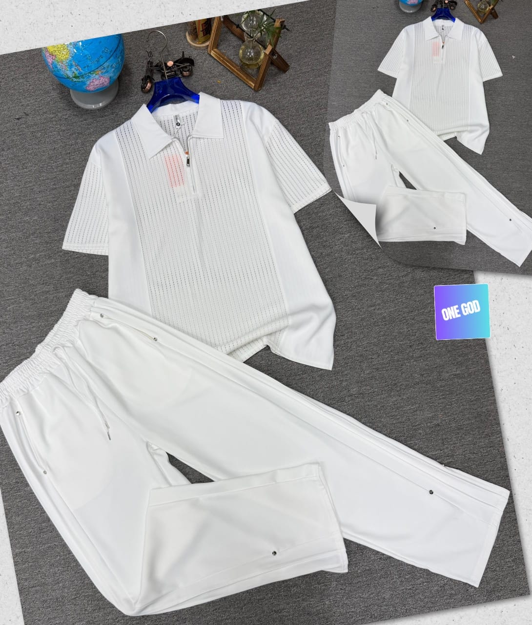 White perforated quarter-zip polo shirt and matching jogger trousers two-piece set.