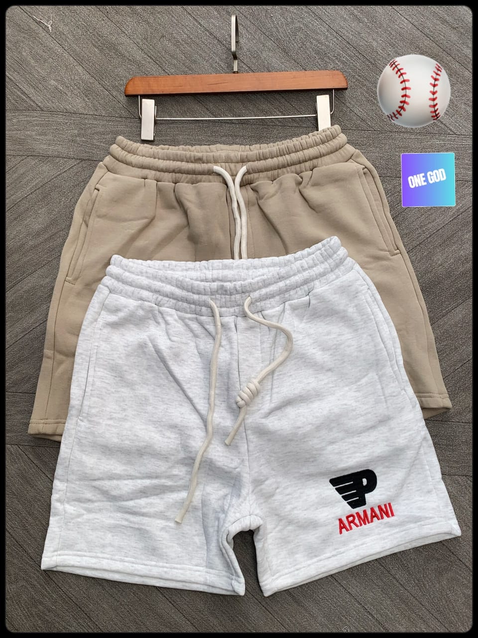 Light gray Armani logo fleece shorts with beige pair in background.
