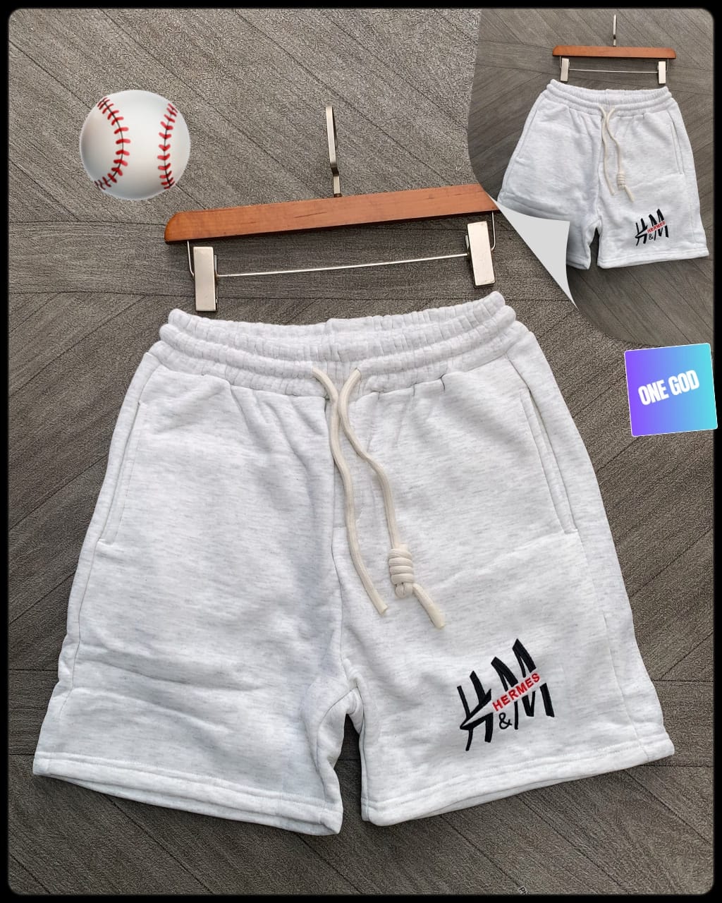 Light gray fleece shorts with Hermes logo on leg and white drawstring.