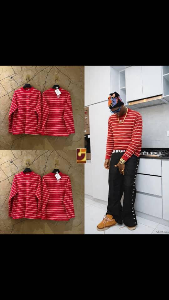 Red striped long sleeve t-shirt displayed on hangers and worn by model.