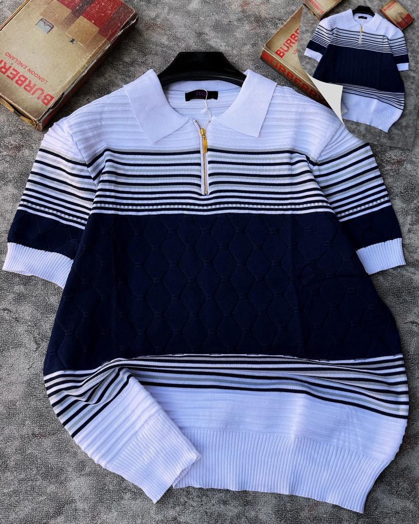Navy and white colorblock knit polo with diamond texture, shown on hanger.