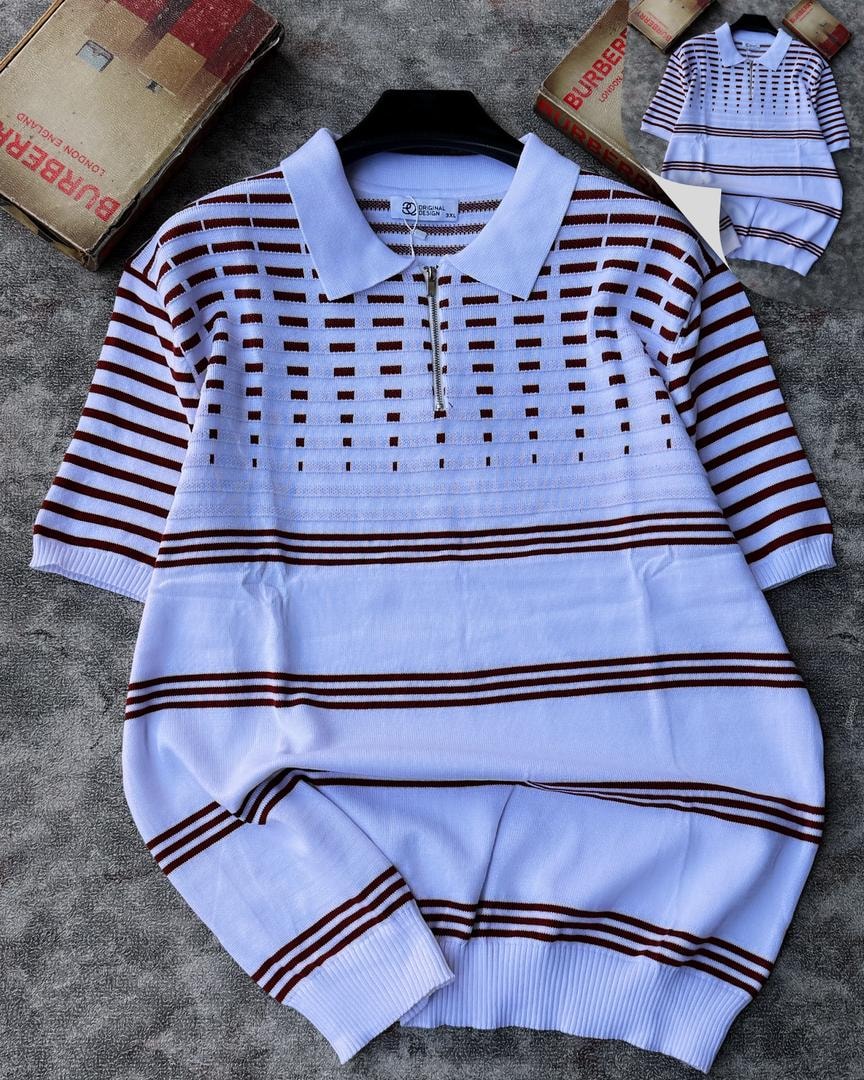 White knit polo with brown stripes and grid pattern on chest, shown on hanger.