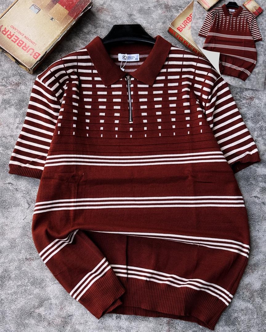 Burgundy knit polo with white stripes and grid pattern on chest, shown on hanger.