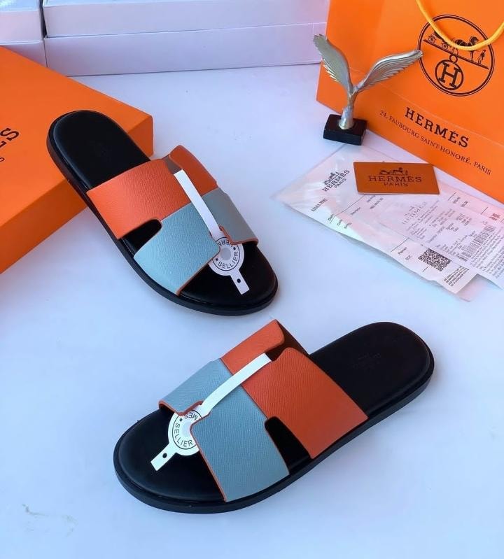 Hermes colorblock slide sandals in orange gray and black with luxury Hermes packaging and receipt.