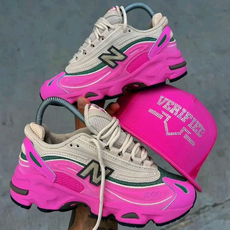 Pink New Balance chunky sneakers with beige, green accents and prominent N logo.