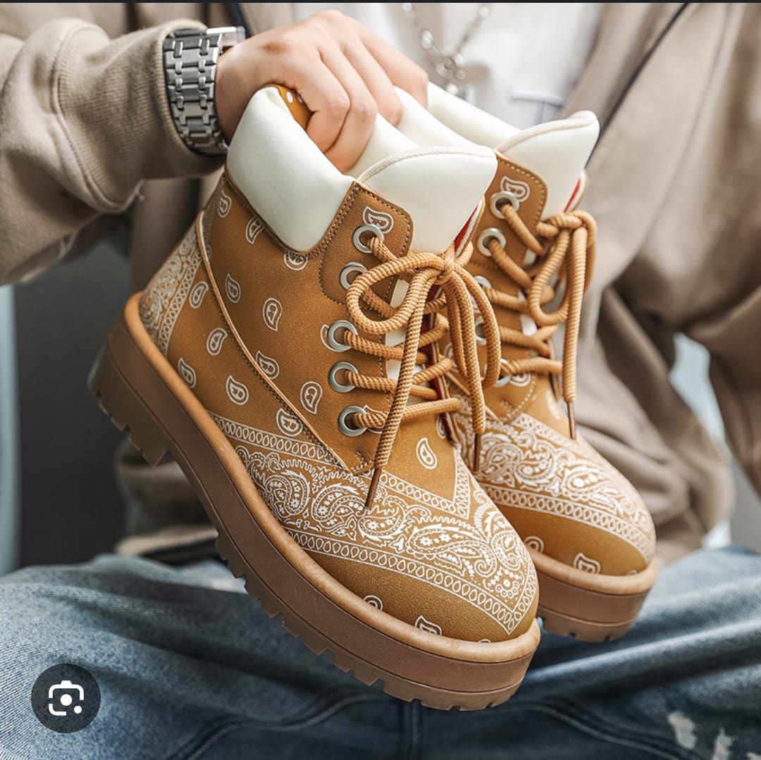 Brown bandana print boots with white collar and chunky lug soles shown in lifestyle shot.