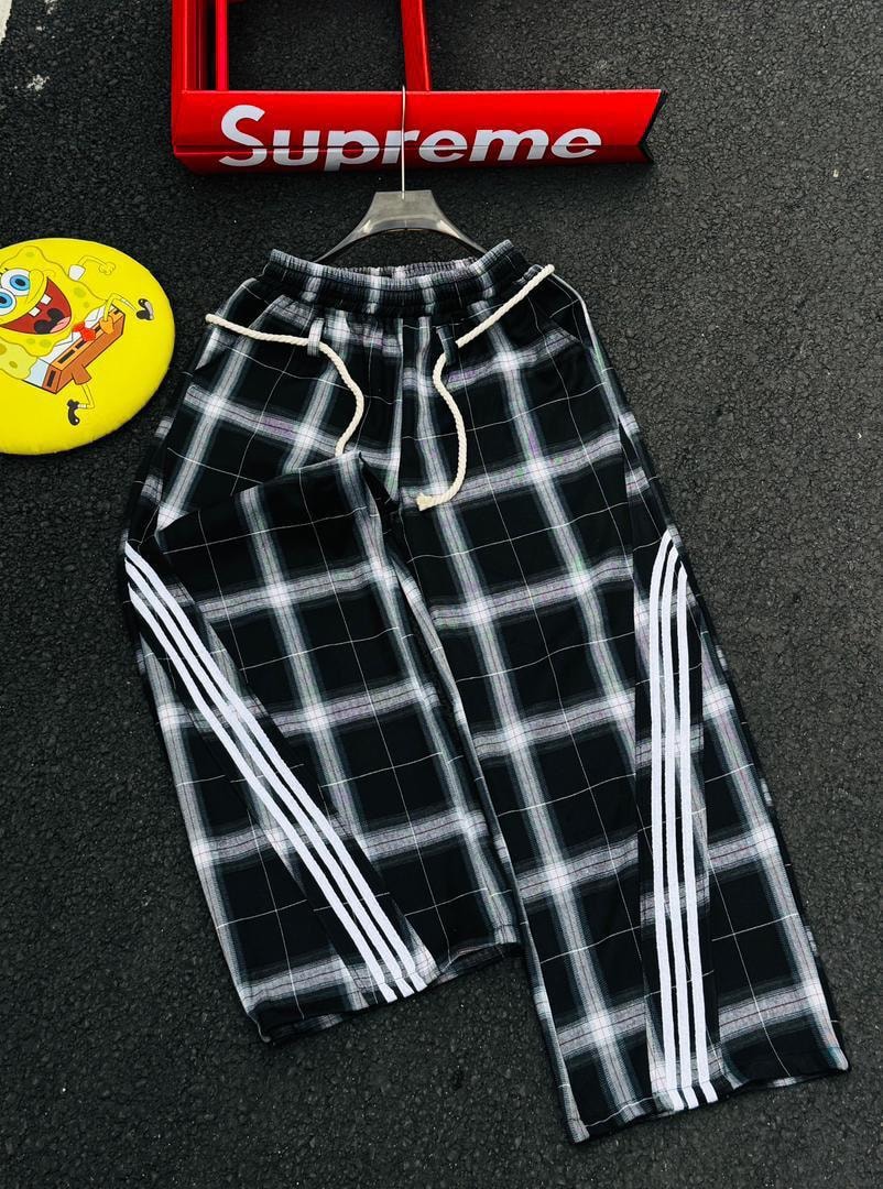 Black and white plaid joggers with white side stripes.