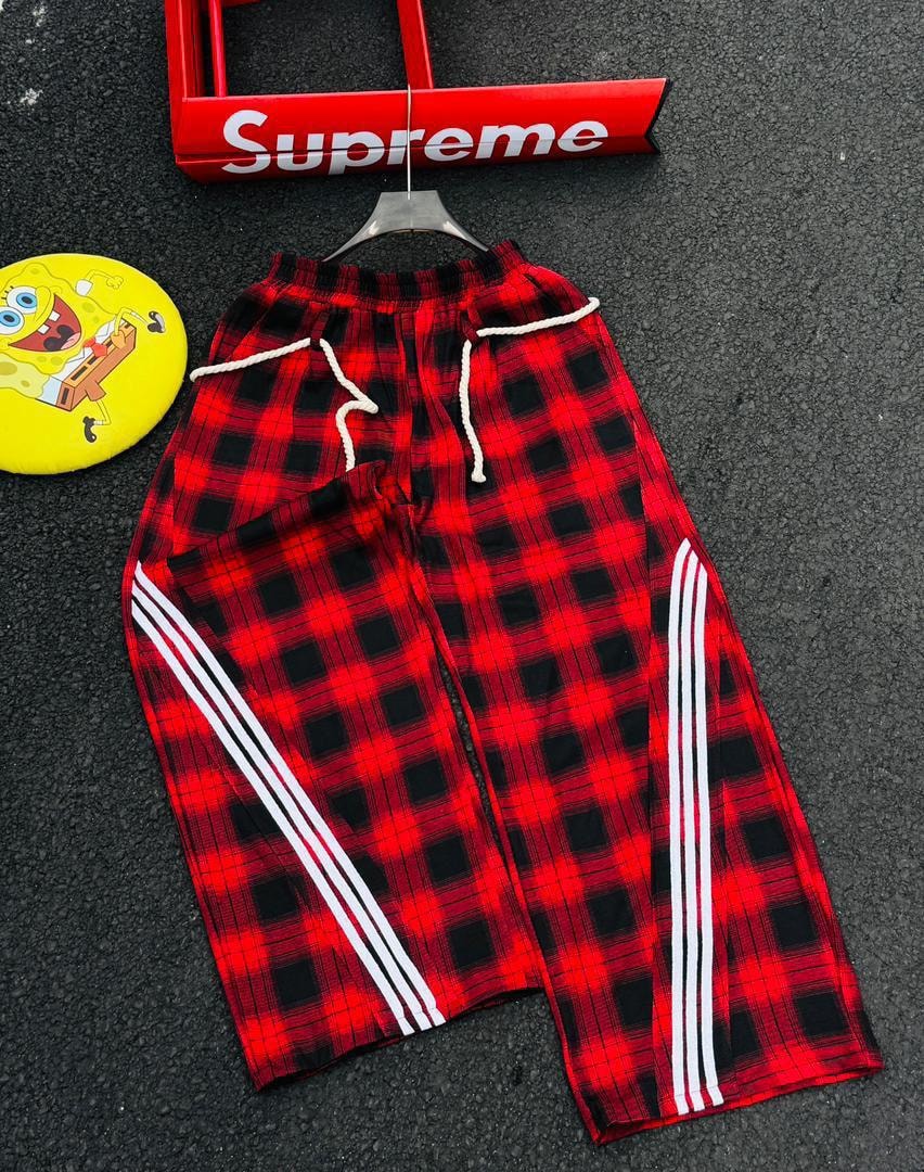 Red and black plaid joggers with white side stripes.