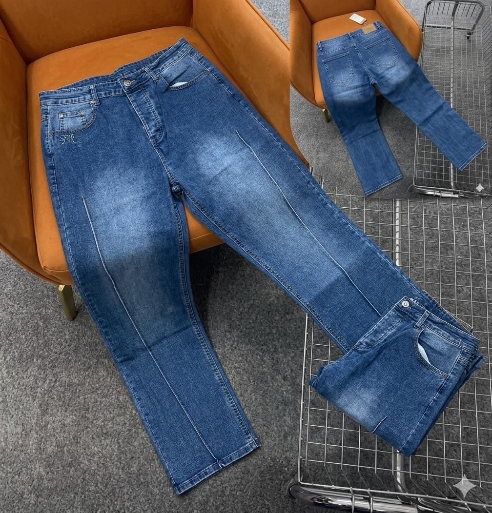 Blue jeans with white contrast stitching and embroidery, shown with back view on orange chair.