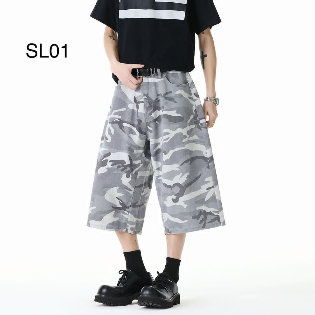 Model wearing gray camouflage wide-leg 3/4 jean shorts