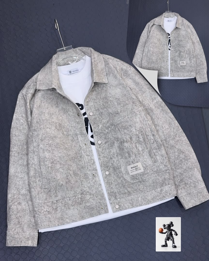 Beige textured button-up jacket layered over white t-shirt.