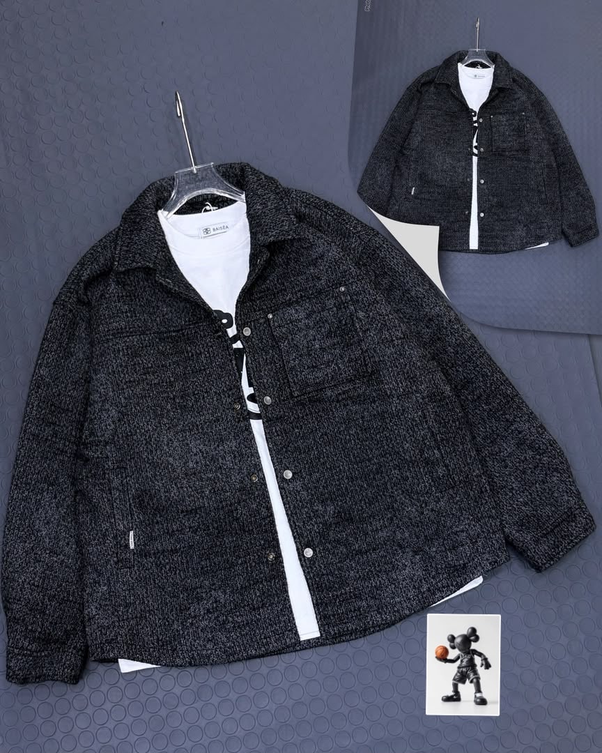 Dark textured oversized jacket shown from front angle on hanger.