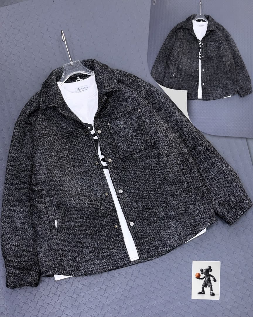 Dark heathered textured jacket displayed on hanger with white inner tee.