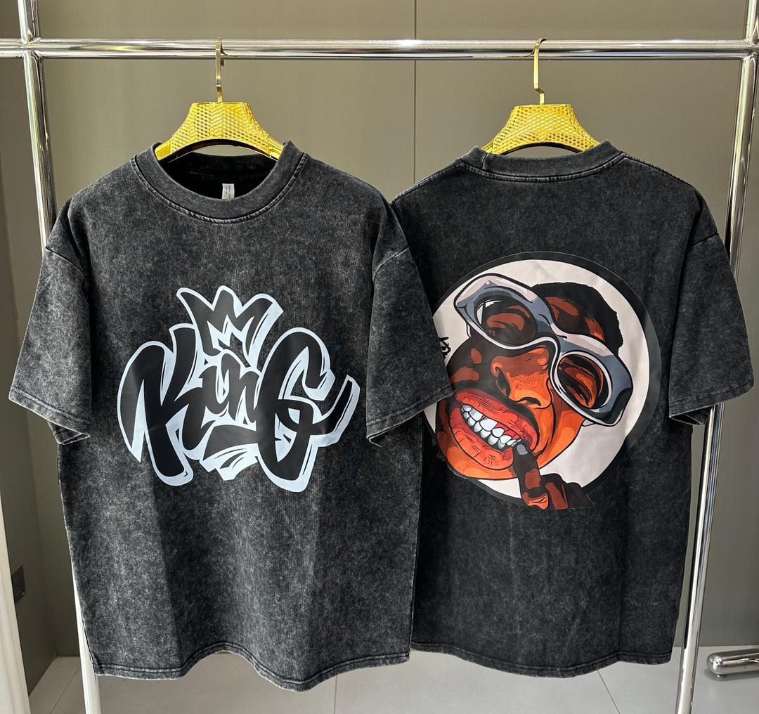 Stone wash t-shirt showing KING graffiti on front and cartoon face with glasses on back.