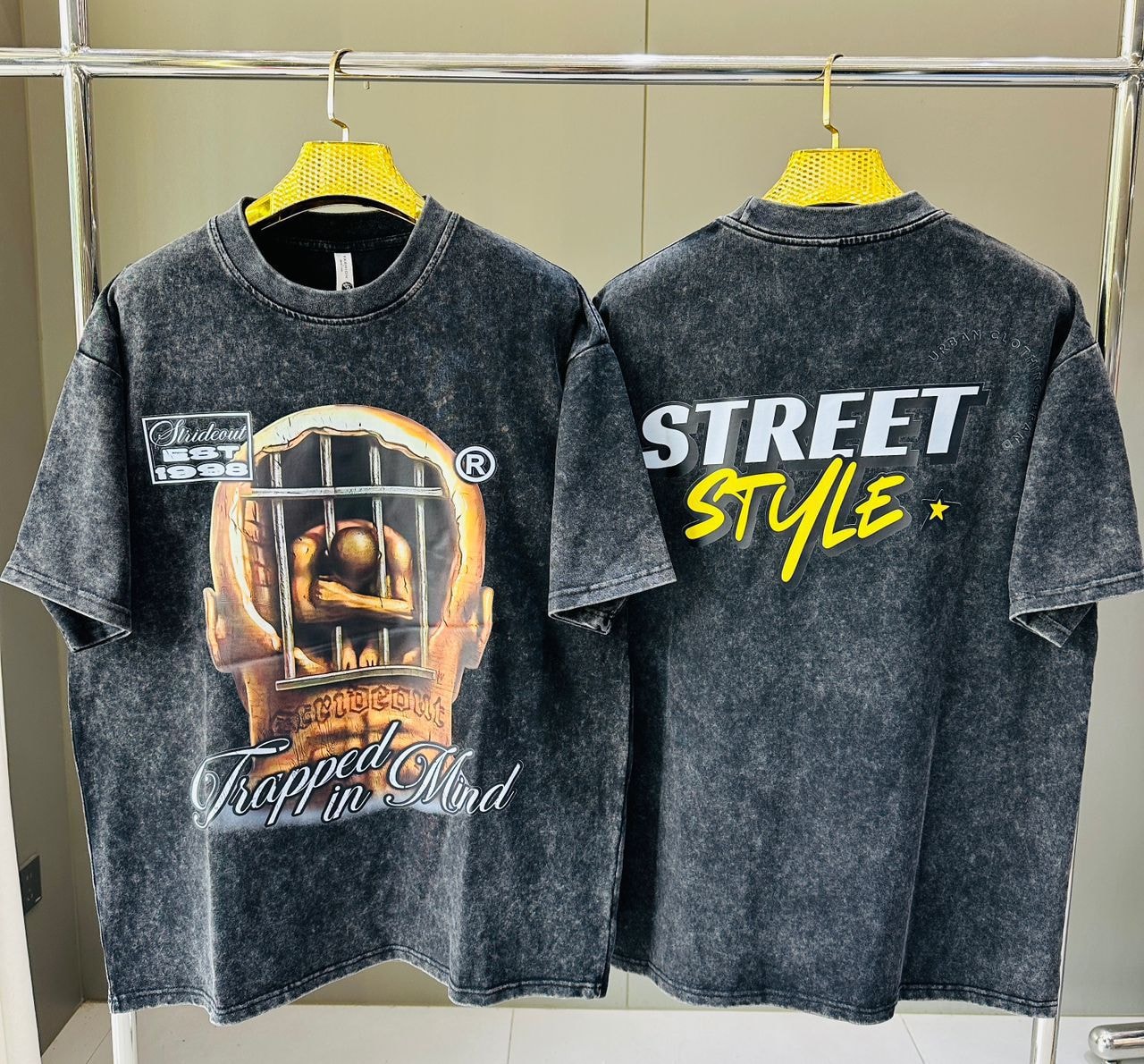 Stone wash t-shirt showing front trapped in mind head in cage graphic and back with STREET STYLE text.