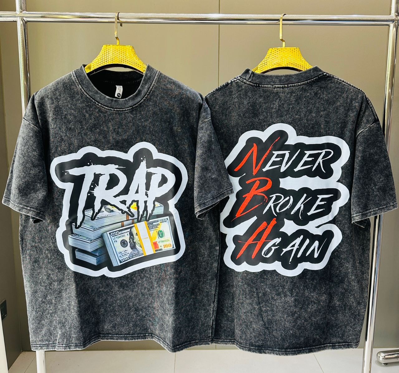 Stone wash t-shirt displaying TRAP money stacks graphic on front and NEVER BROKE AGAIN text on back.