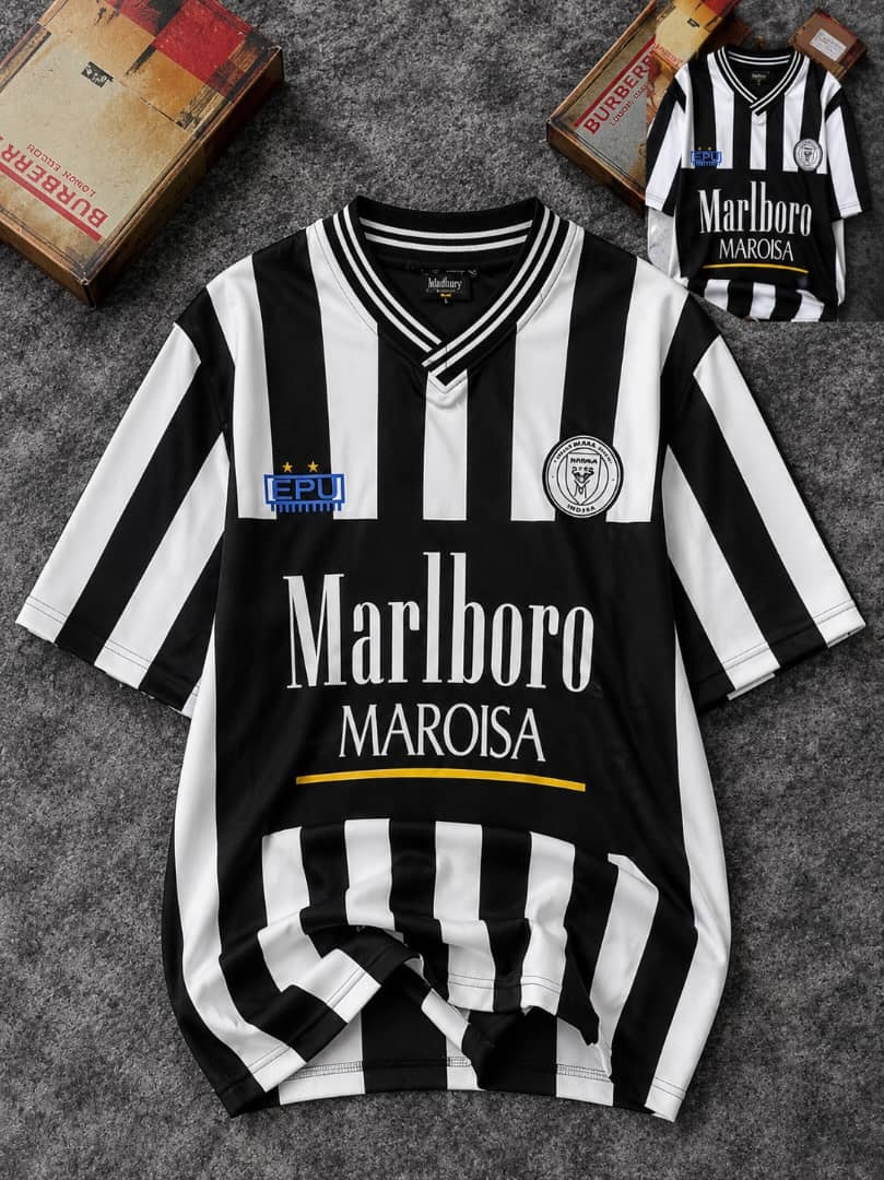 Black and white striped soccer jersey with Marlboro Maroisa branding and logos on front, shown flat with small inset view.