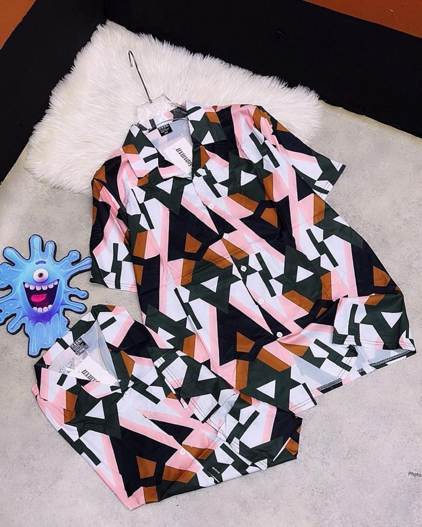 Short sleeve shirt with pink, black, green and brown geometric triangle pattern.