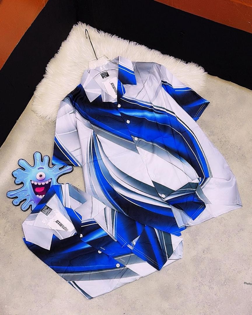 White short sleeve shirt featuring blue abstract curved and striped patterns.