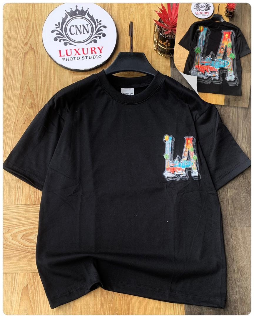 Black t-shirt with colorful LA city graphic on chest.