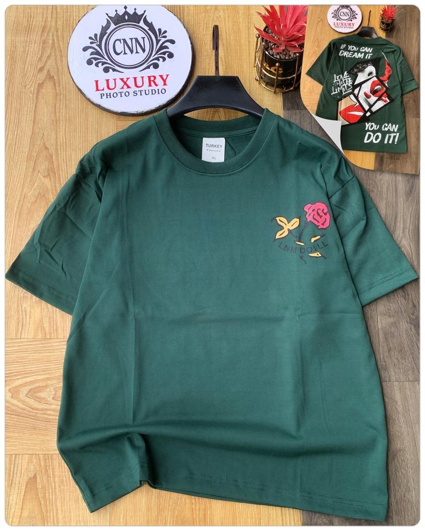 Green t-shirt with rose, butterfly and text graphic on chest.