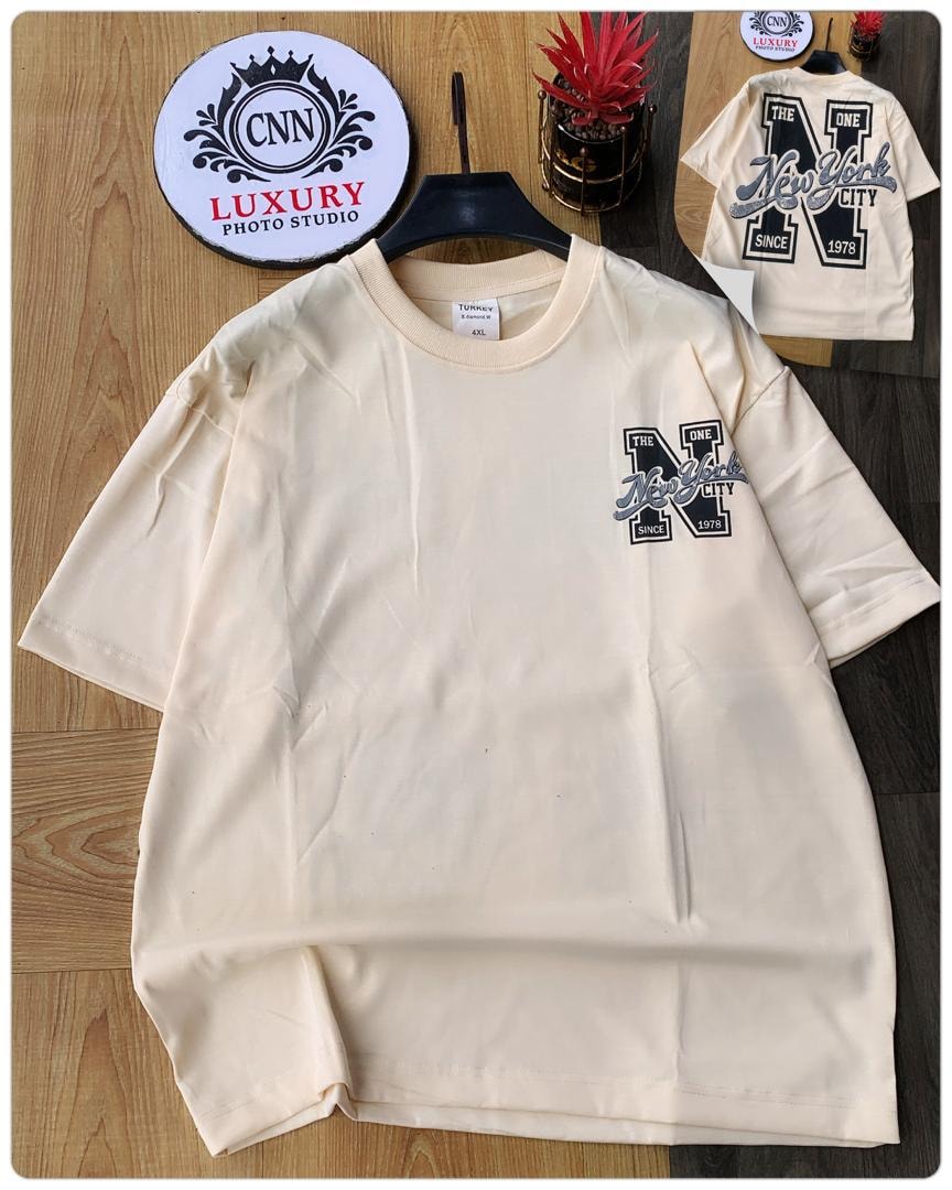 Cream t-shirt with New York City logo print on chest.