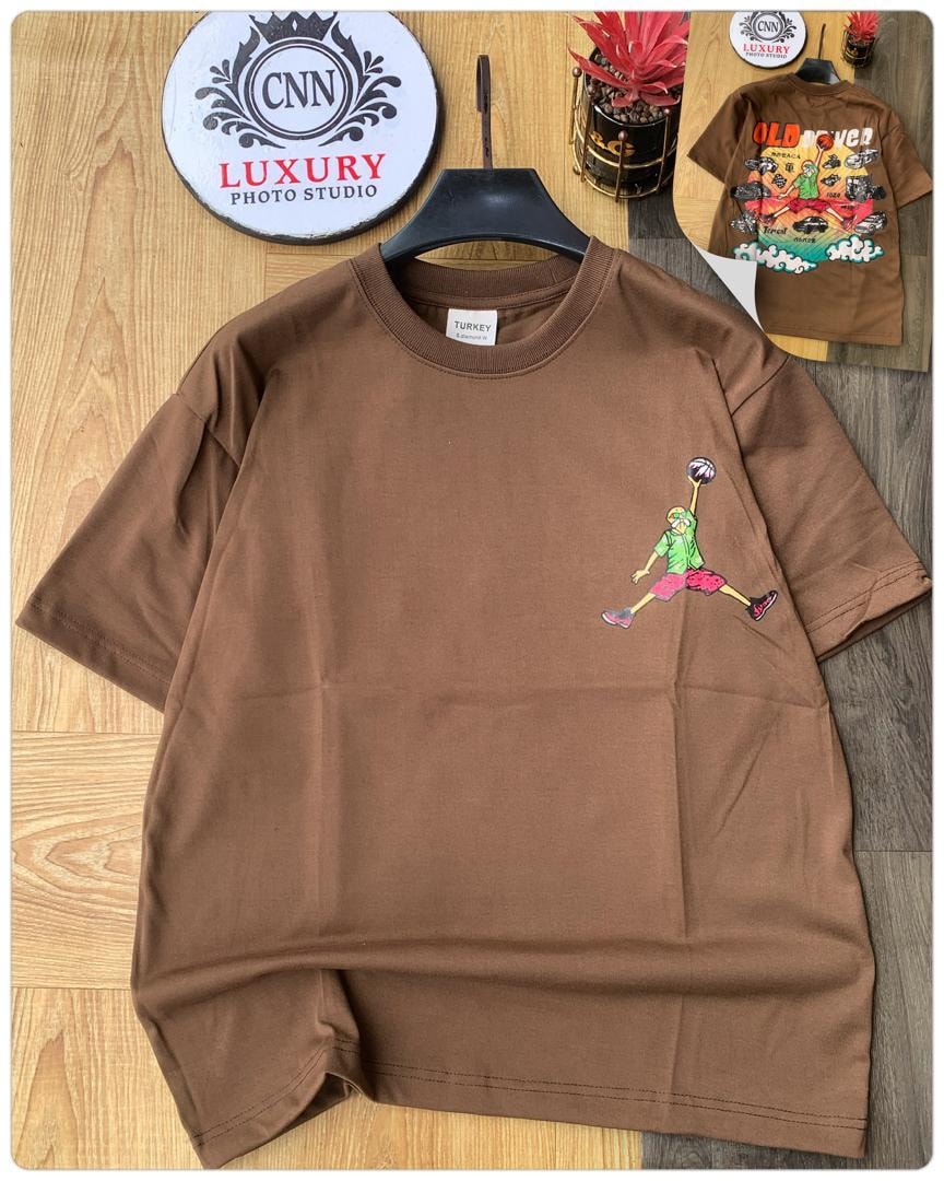 Brown t-shirt with basketball player jumping graphic on chest.