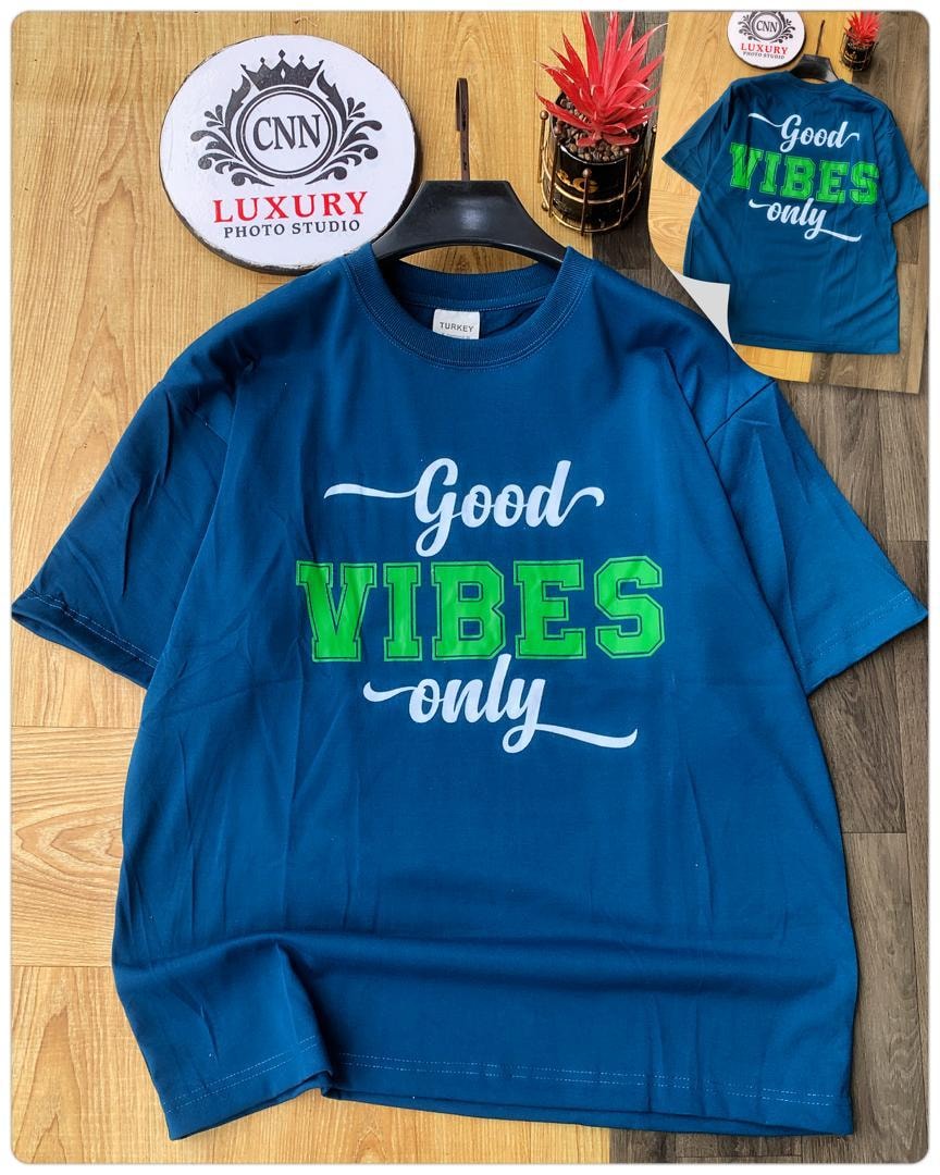 Blue t-shirt with Good Vibes Only text graphic.
