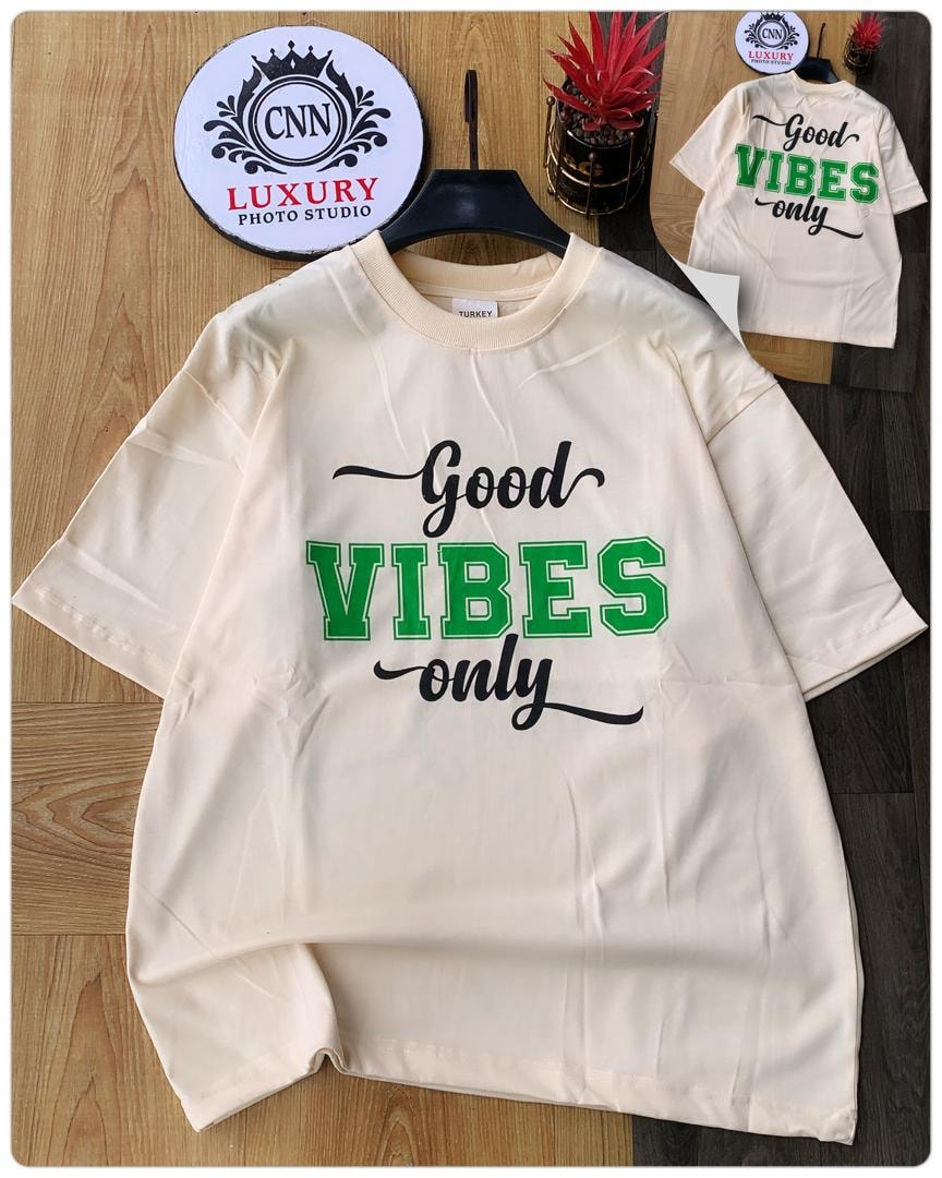 Cream t-shirt with Good Vibes Only text graphic.