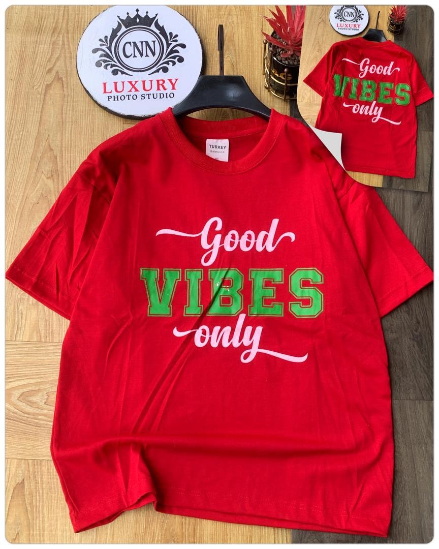 Red t-shirt with Good Vibes Only text graphic.
