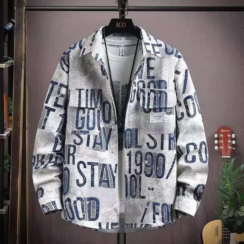 White shirt with blue all-over typographic prints hanging on a black hanger.