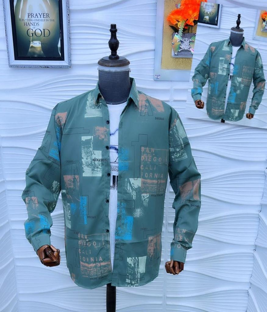 Green abstract collage print button-down shirt on white textured background.