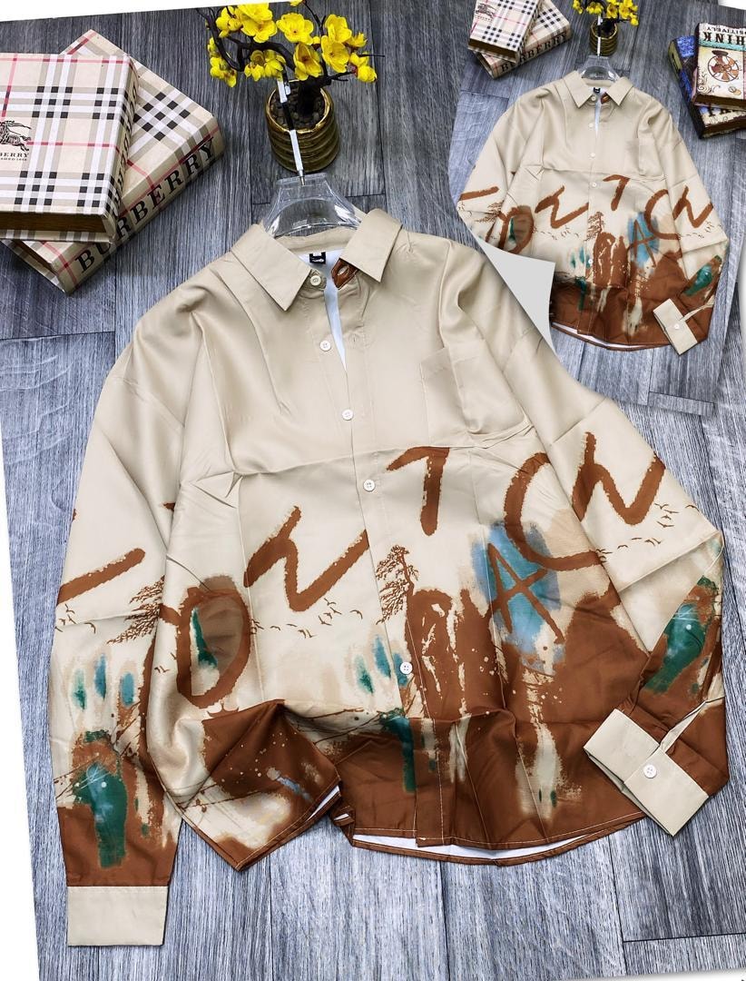 Beige shirt with brown graffiti print and ink wash details laid flat with inset.