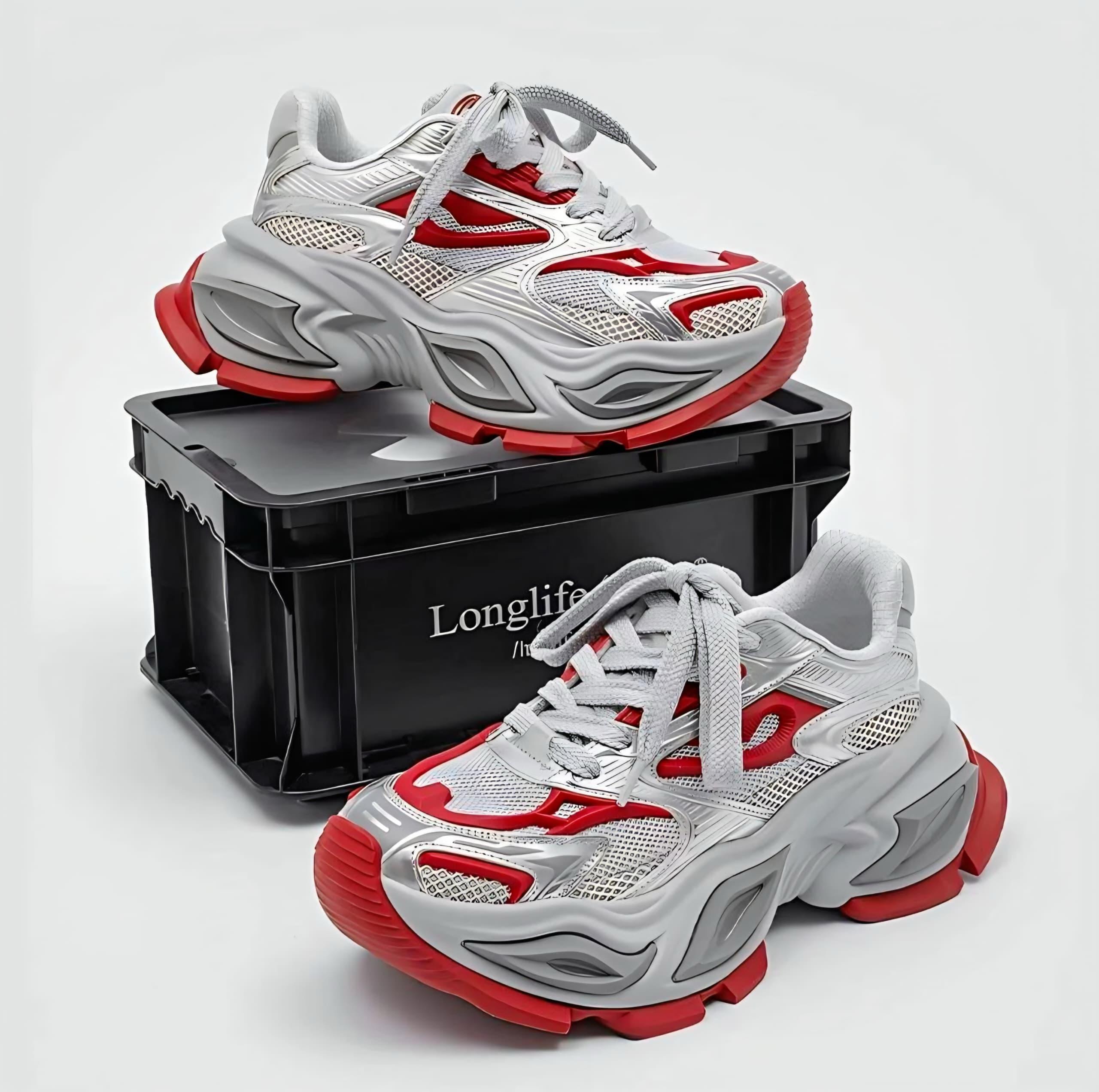 Gray red and white chunky sneakers with black storage box.