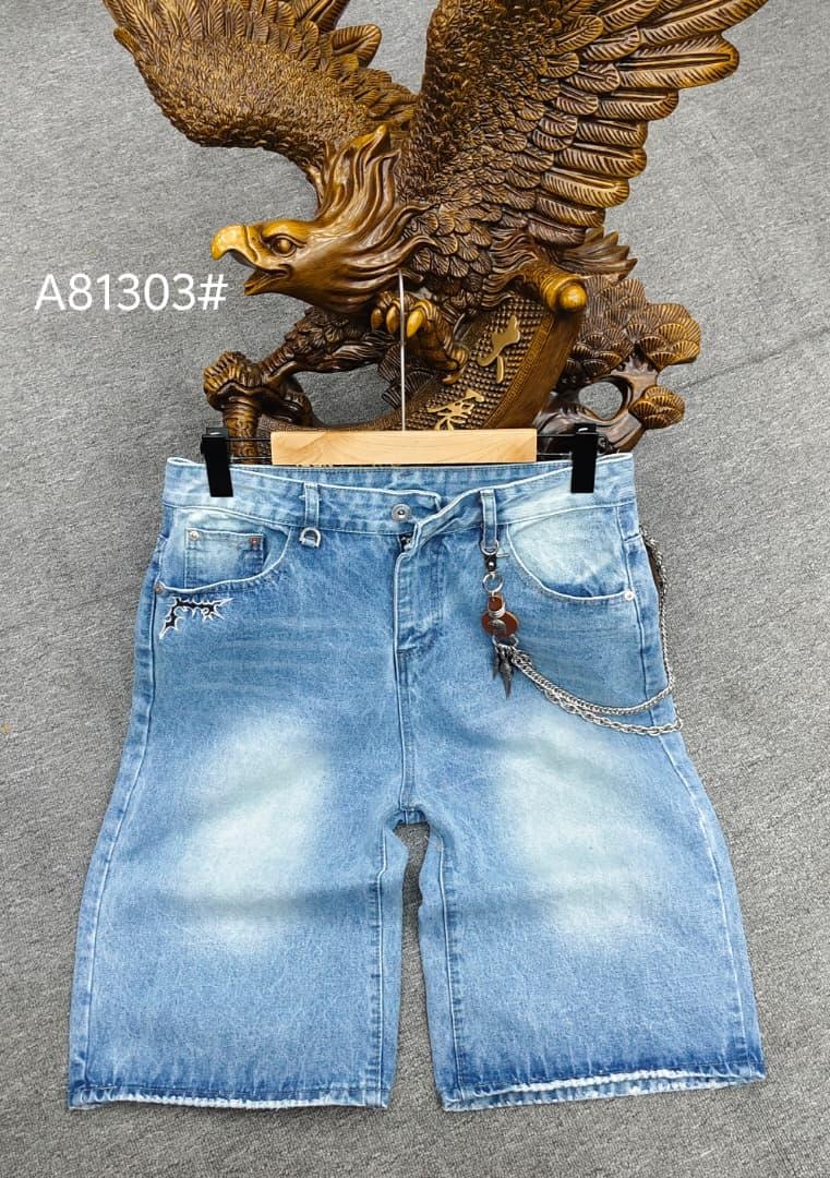 Light blue denim 3/4 shorts with chain and pendant hanging from pocket, displayed with eagle statue.