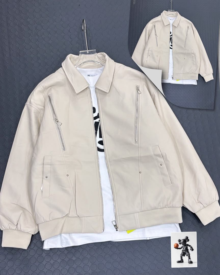 Beige collared zip jacket on gray background with white tee layered underneath.