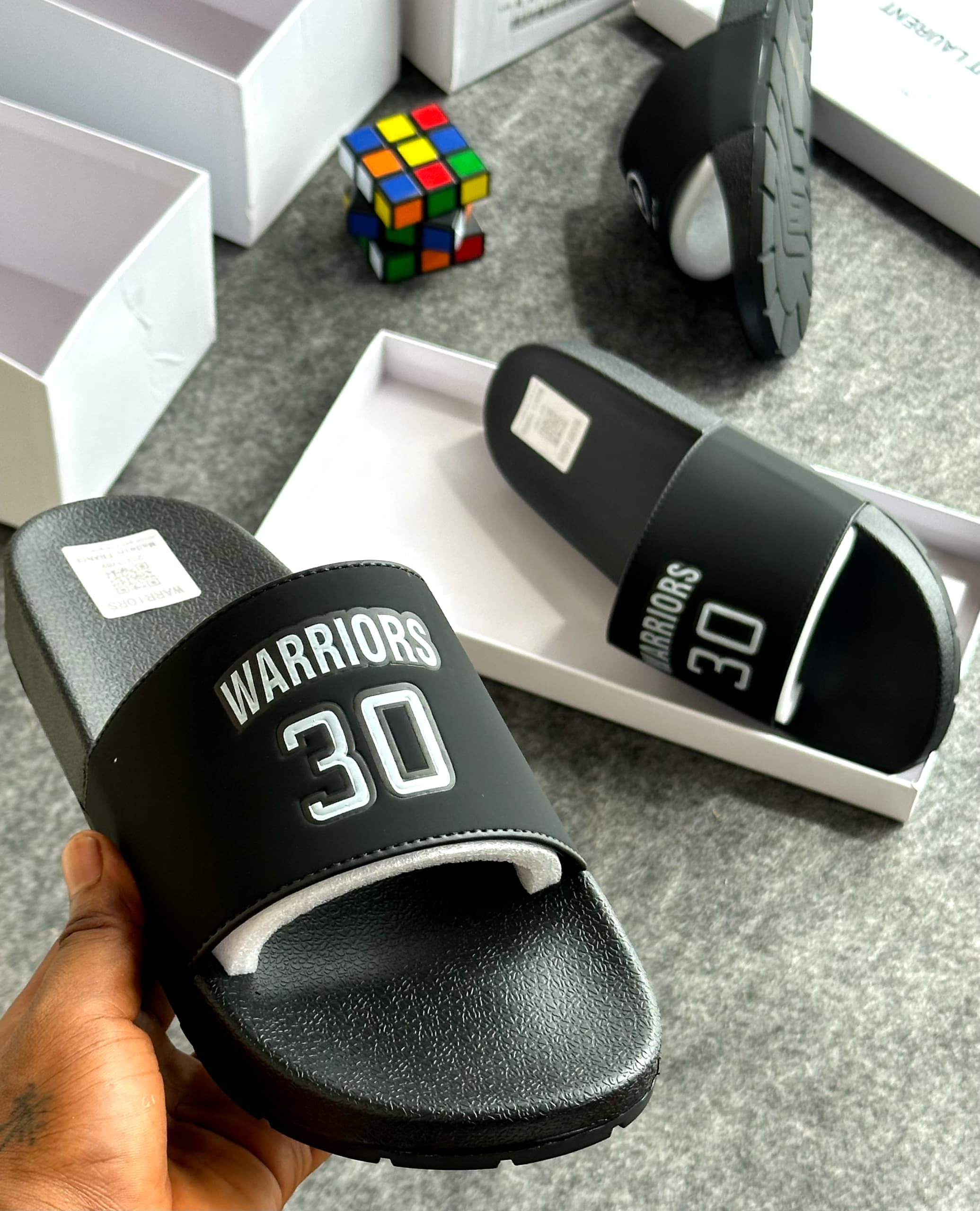 Black Warriors 30 slides with large number graphic held in hand next to packaging.