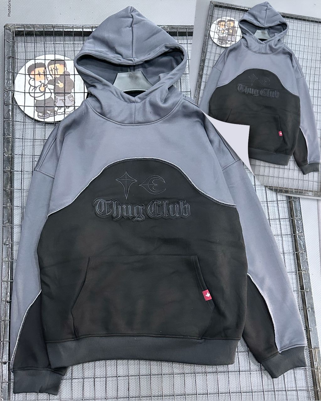 Gray and black Thug Club colorblock hoodie with embroidery, front view on grid background.