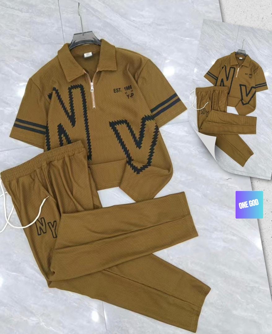 Mustard ribbed polo and trousers two-piece set with large NY zigzag graphic and EST 1986 text.