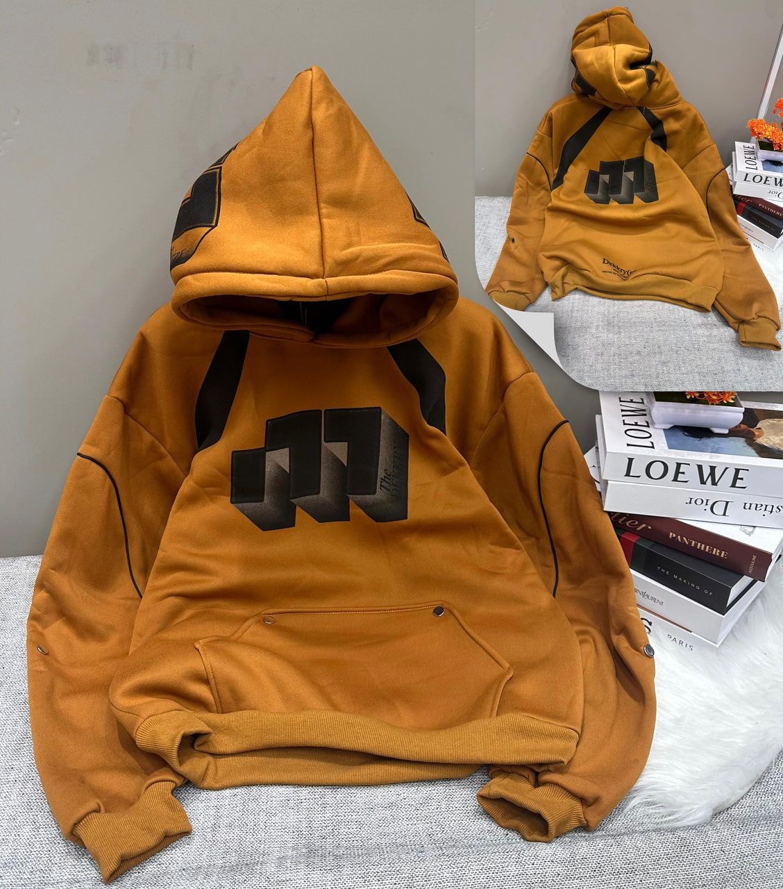 Mustard geometric graphic hoodie shown in flat lay and styled view with black abstract designs.