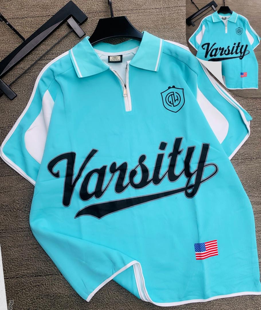 Light blue Varsity quarter-zip polo shirt with white trim and graphic prints.