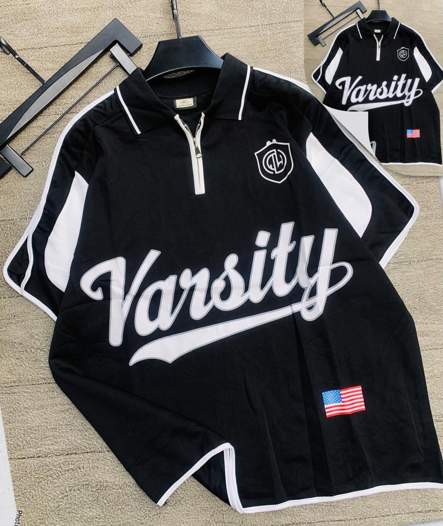 Black Varsity quarter-zip polo shirt with white trim and graphic prints.